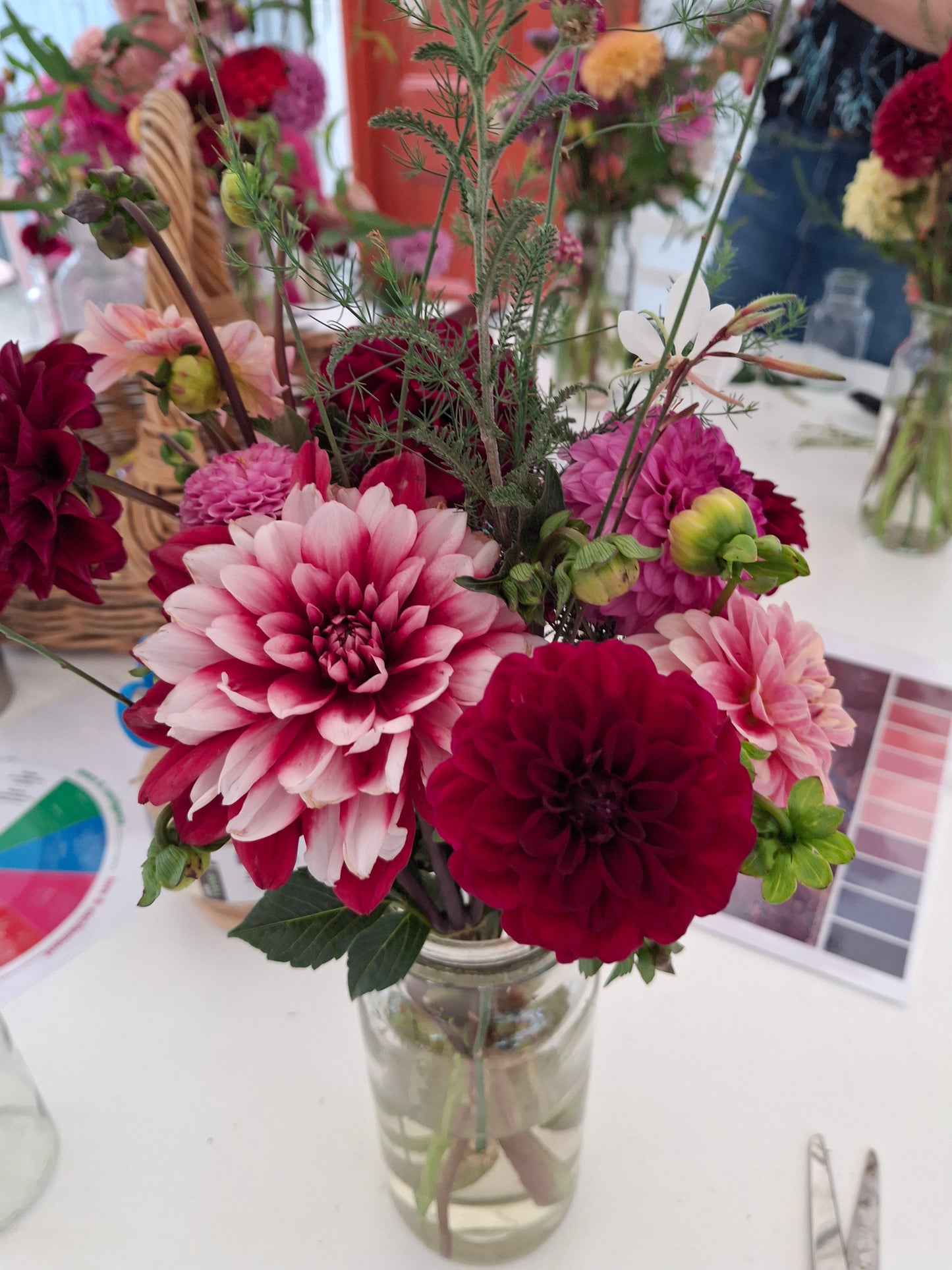 Bouquet of red and pink flowers in a mason jar