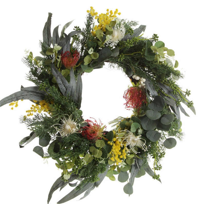 Decorative Christmas wreath with greenery and colorful flowers on a white background